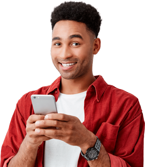 man in red shird with white inner tshirt smiling while holding smartphone with both hands